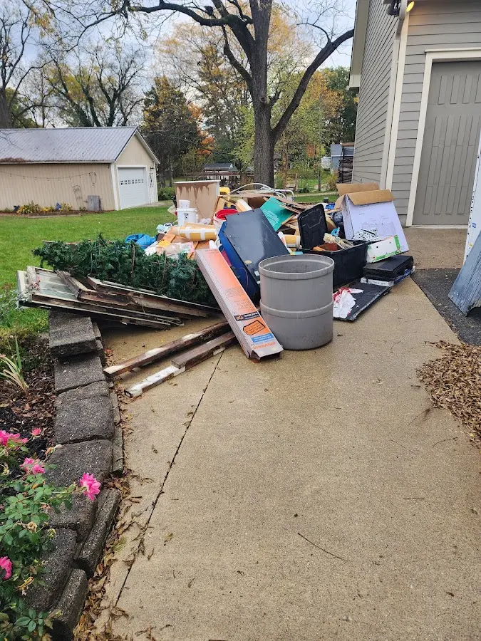 Dumpster being loaded with debris for 12 Yard Dumpster Rental in Sheboygan Falls